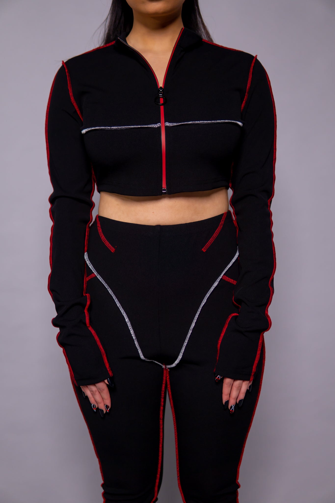 Oversized sleeve detail with red zip and cropped style, matching trousers with jacket